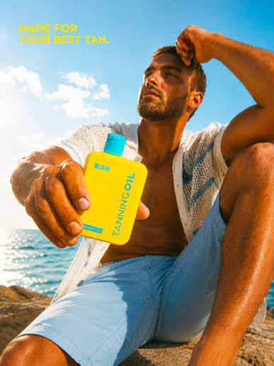 Eight Fifty tanning oil held by the sea